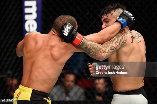 John Dodson punches John Lineker of Brazil in their bantamweight bout during the UFC Fight Night event at the Moda Center on October 1, 2016 in...
