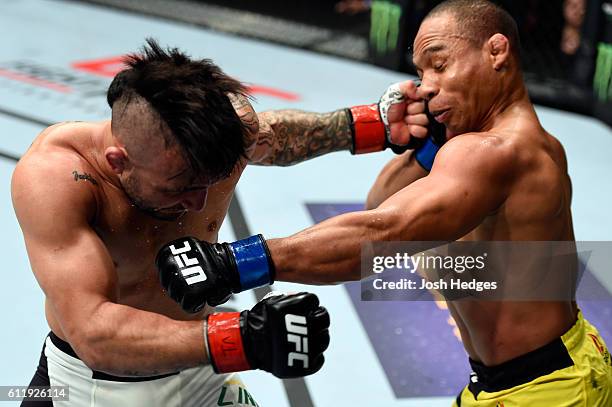 John Dodson and John Lineker of Brazil exchange punches in their bantamweight bout during the UFC Fight Night event at the Moda Center on October 1,...