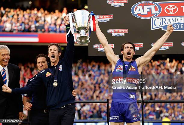 Robert Murphy and Easton Wood of the Bulldogs hold up the the premiership cup during the 2016 Toyota AFL Grand Final match between the Sydney Swans...