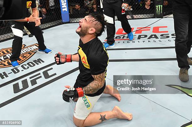 John Lineker of Brazil celebrates after defeating John Dodson by split decision in their bantamweight bout during the UFC Fight Night event at the...