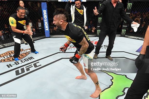 John Lineker of Brazil celebrates after defeating John Dodson by split decision in their bantamweight bout during the UFC Fight Night event at the...