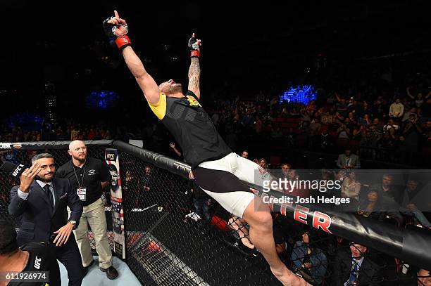 John Lineker of Brazil celebrates after defeating John Dodson by split decision in their bantamweight bout during the UFC Fight Night event at the...