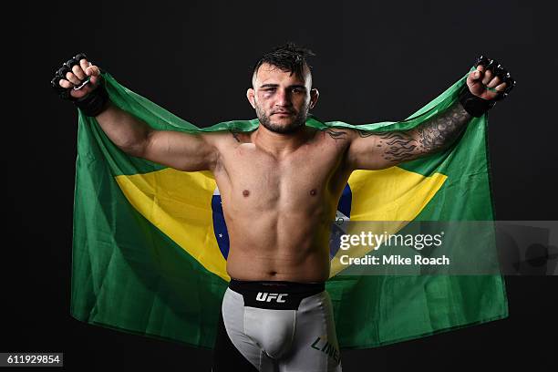 John Lineker of Brazil poses for a post fight portrait backstage after defeating John Dodson during the UFC Fight Night event at the Moda Center on...