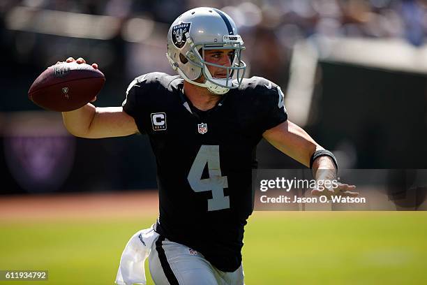 Quarterback Derek Carr of the Oakland Raiders passes against the Atlanta Falcons during the third quarter at Oakland-Alameda County Coliseum on...