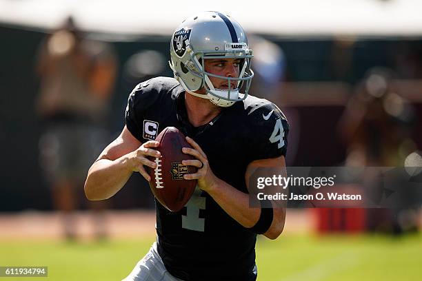 Quarterback Derek Carr of the Oakland Raiders looks to pass against the Atlanta Falcons during the third quarter at Oakland-Alameda County Coliseum...