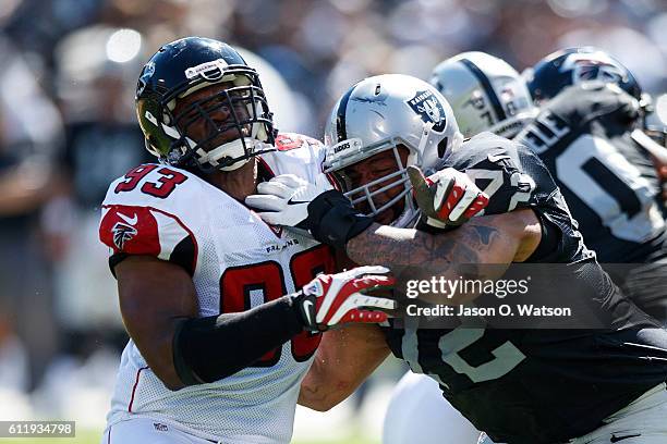 Defensive end Dwight Freeney of the Atlanta Falcons is blocked by tackle Donald Penn of the Oakland Raiders during the second quarter at...