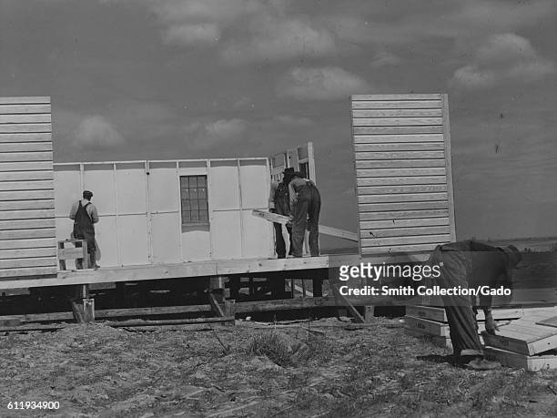 Men put the walls up on a house at the Farm Security Administration project in Pacolet, South Carolina, 1940. .