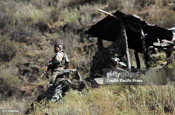 An Indian trooper standing alert near a temporary bunker in Uri sector, which is approximately 110 KM far from summer capital of the state. Tension...