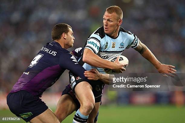 Luke Lewis of the Sharks is tackled during the 2016 NRL Grand Final match between the Cronulla Sharks and the Melbourne Storm at ANZ Stadium on...
