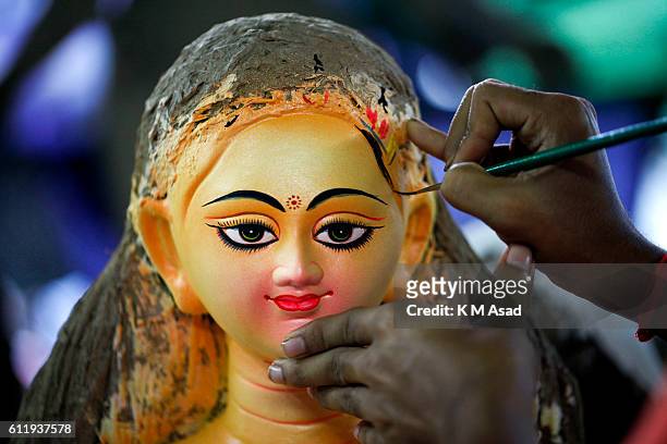Bangladeshi artist works on a clay idol of Goddess Durga for the upcoming Durga Puja festival at old Dhaka, Bangladesh. Bengalis all over the world...