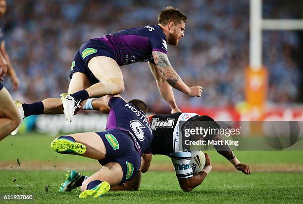 Ben Barba of the Sharks is tackled as Cameron Munster of the Storm goes over the top during the 2016 NRL Grand Final match between the Cronulla...