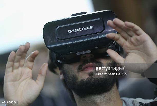 Visitor explores a Virtual Reality landscape with VR goggles at the 2016 Berlin Maker Faire on October 1, 2016 in Berlin, Germany. The Maker Faire...