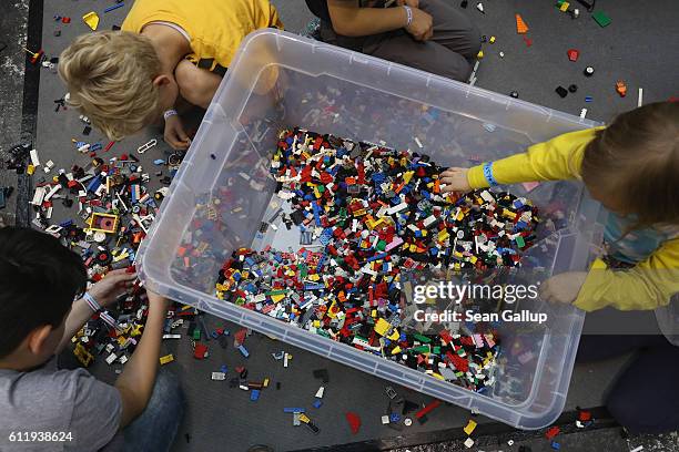 Children play with Legos at the 2016 Berlin Maker Faire on October 1, 2016 in Berlin, Germany. The Maker Faire combines a trade fair with hands-on...
