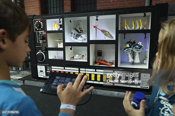 Children, including a boy whose mother said she did not mind him being photographed, try out a music installation at the 2016 Berlin Maker Faire on...