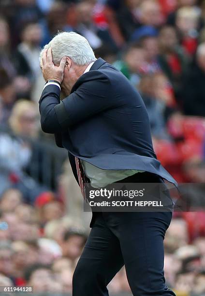 Stoke City's Welsh manager Mark Hughes reacts on the touchline during the English Premier League football match between Manchester United and Stoke...