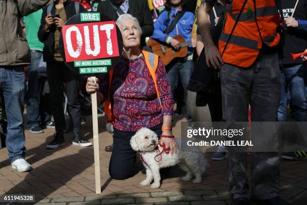 Anti-conservative protesters hold placards during a rally in Victoria Square in Birmingham, central England, on October 2, 2016 on the first day of...