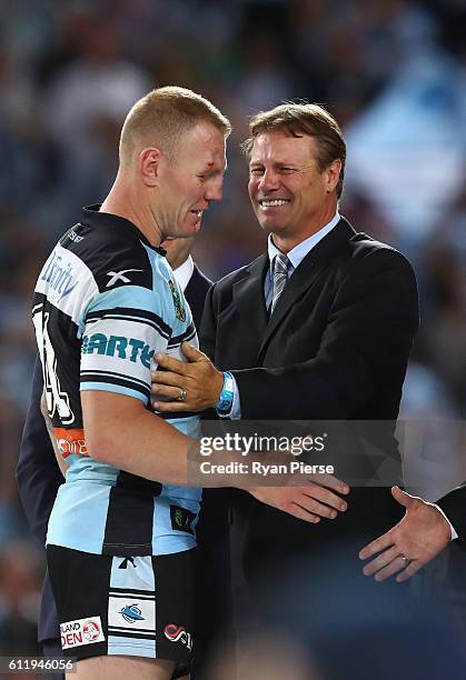 Luke Lewis of the Sharks is congratulated by former Sharks player Andrew Ettingshausen during the 2016 NRL Grand Final match between the Cronulla...