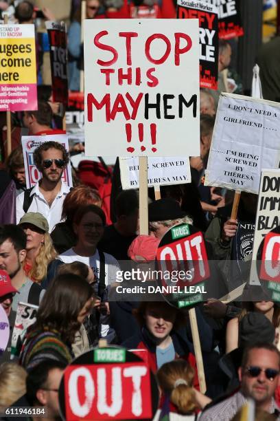 Anti-conservative protesters hold placards during a rally in Victoria Square in Birmingham, central England, on October 2, 2016 on the first day of...