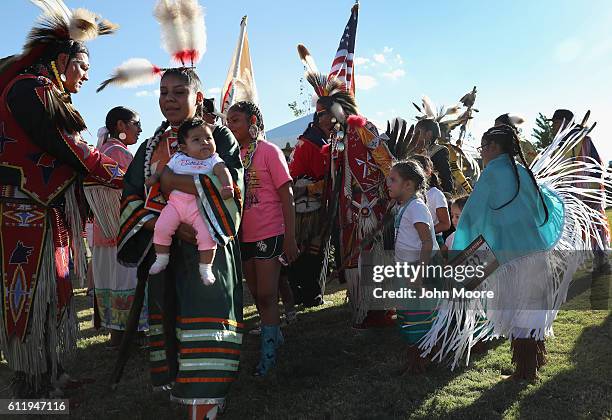 Native Americans take part in the grand entry of traditional dancers at the "Rocking the Rez" Pow Wow on October 1, 2016 in Ysleta del Sur Pueblo,...