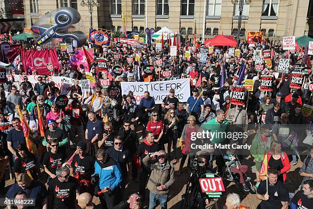 Protesters hold various signs during a TUC demonstration against austerity on the first day of the Conservative Party Conference 2016 on October 2,...