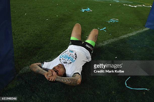 Andrew Fifita of the Sharks lies on the spot where he scored a try as he celebrates victory in the 2016 NRL Grand Final match between the Cronulla...