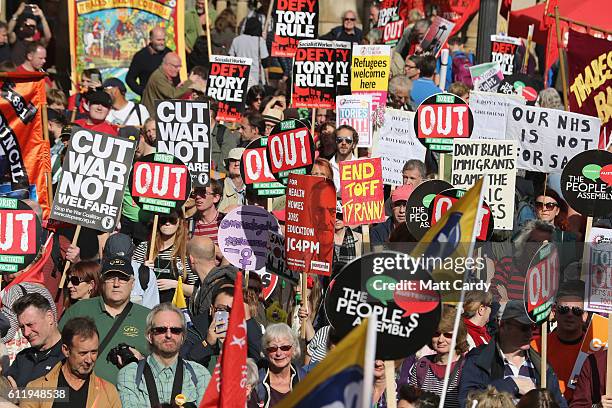 Protesters hold various signs during a TUC demonstration against austerity on the first day of the Conservative Party Conference 2016 on October 2,...