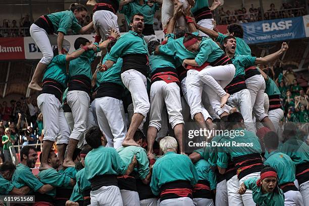 Members of the colla 'Castellers de Vilafranca' celebrate after building a human tower during the 26th Tarragona Competition on October 2, 2016 in...
