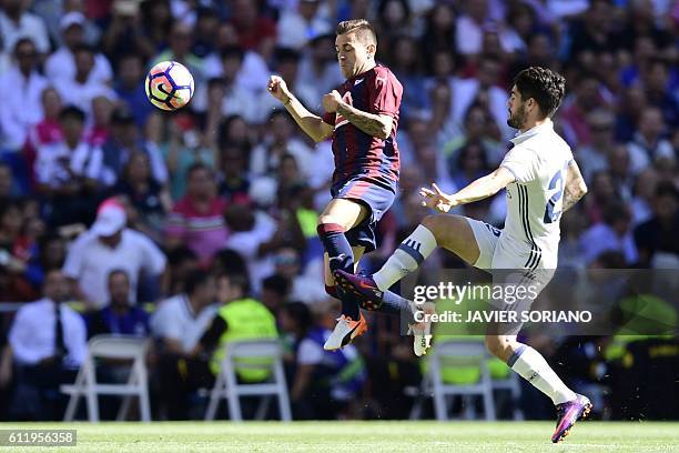 Eibar's midfielder Eibar's midfielder Fran Rico vies with Real Madrid's midfielder Isco during the Spanish league football match Real Madrid CF vs SD...