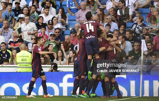 Eibar's midfielder Eibar players celebrate after scoring a goal during the Spanish league football match Real Madrid CF vs SD Eibar at the Santiago...