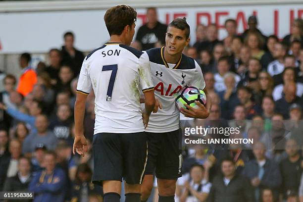Tottenham Hotspur's South Korean striker Son Heung-Min and Tottenham Hotspur's Argentinian midfielder Erik Lamela clash before Tottenham Hotspur's...