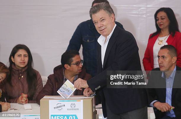 Colombia's President Juan Manuel Santos casts his ballot in the referendum on a peace accord to end the 52-year-old guerrilla war between the FARC...