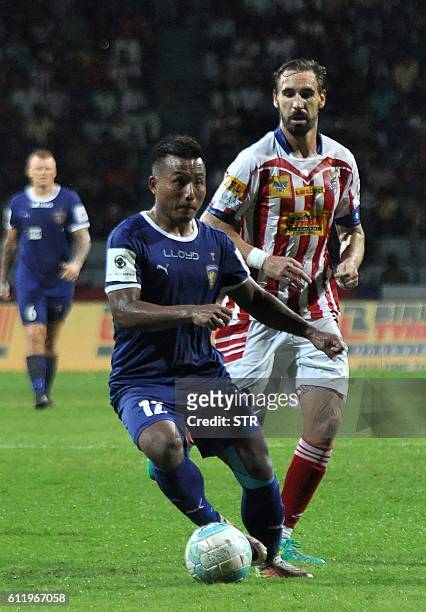 Atletico de Kolkata's midfielder Borja Fernandez looks on as Chennaiyin FC's forward Jeje Lalpekhlua controls the ball during the Indian Super League...