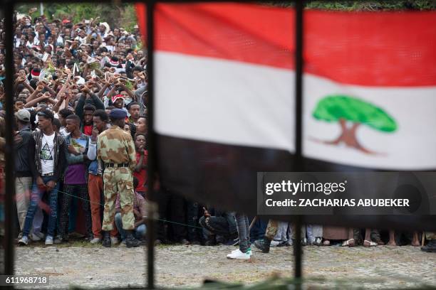 People cross their wrists above their heads during the Oromo new year holiday Irreechaa in Bishoftu on October 2, 2016. Several people were killed in...