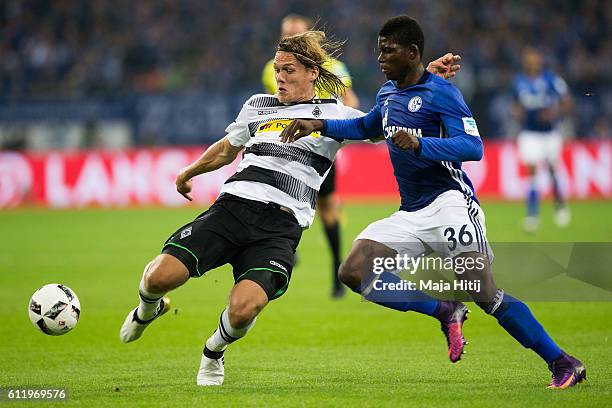 Uilson de Souza Paula Junior of Schalke is challenged by Jannik Vestergaard of Moenchengladbach during the Bundesliga match between FC Schalke 04 and...