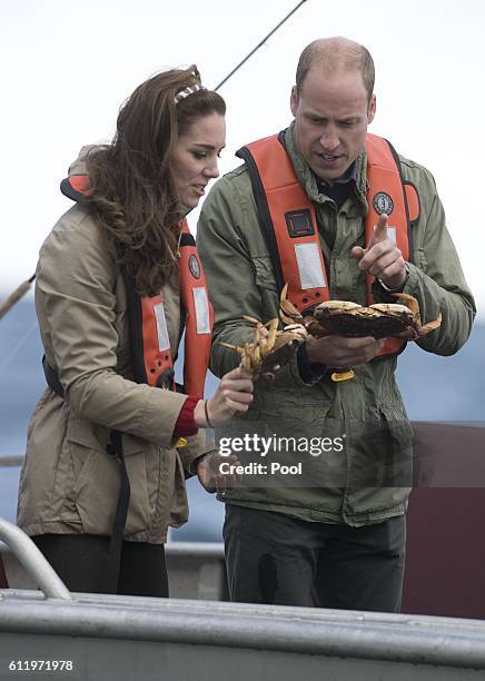 Prince William, Duke of Cambridge and Catherine, Duchess of Cambridge inspect crabs during a fishing boat trip on September 30, 2016 in Haida Gwaii,...