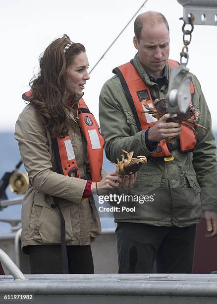 Prince William, Duke of Cambridge and Catherine, Duchess of Cambridge inspect crabs during a fishing boat trip on September 30, 2016 in Haida Gwaii,...