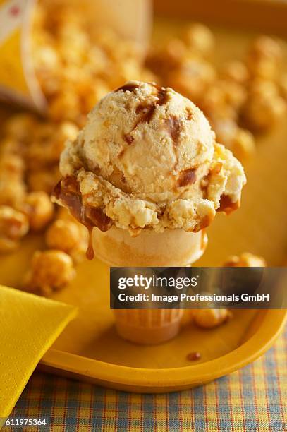 caramel ice cream cone with caramel corn - caramel popcorn stock pictures, royalty-free photos & images