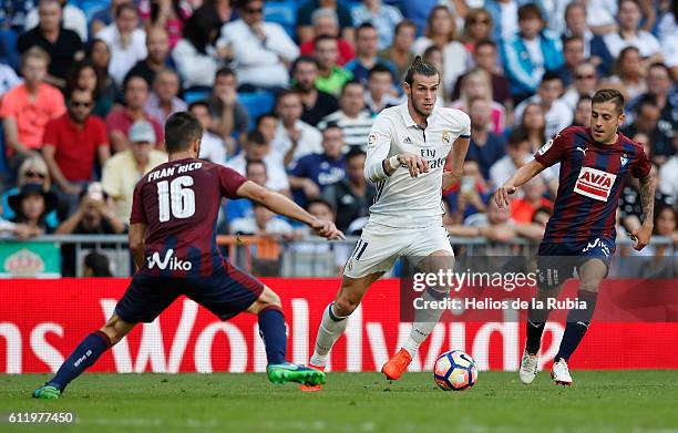 Gareth Bale of Real Madrid against Ruben Pena and Fran Rico of Eibar FC compete for the ball during the La Liga match between Real Madrid CF and SD...