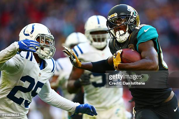 Allen Hurns of the Jacksonville Jaguars hands off Patrick Robinson of the Indianapolis Colts to score a touchdown during the NFL game between...