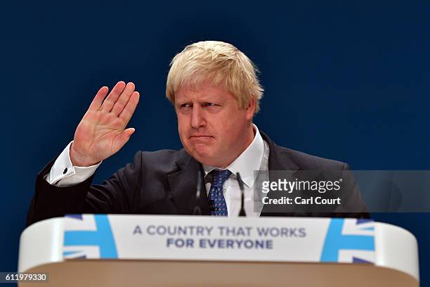 Foreign Secretary Boris Johnson puts up his hand as he delivers a speech about Brexit on the first day of the Conservative Party Conference 2016 at...