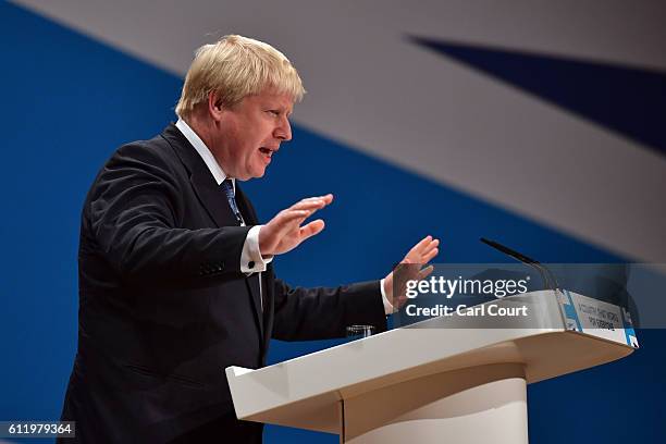 Foreign Secretary Boris Johnson raises his hands as he delivers a speech about Brexit on the first day of the Conservative Party Conference 2016 at...