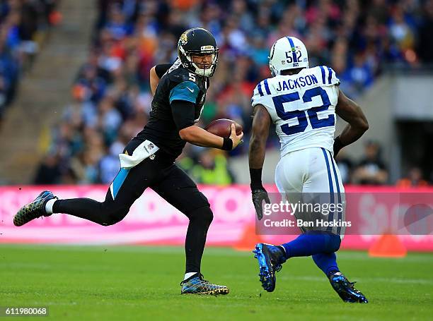 Blake Bortles of Jacksonville runs at D'Qwell Jackson of Indianapolis during the NFL International Series match between Indianapolis Colts and...