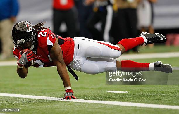 Devonta Freeman of the Atlanta Falcons dives for a touchdown against the Carolina Panthers at Georgia Dome on October 2, 2016 in Atlanta, Georgia.