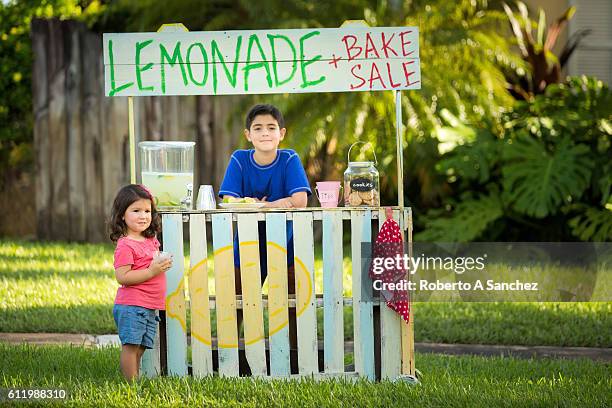 siblings selling lemonade on stand - annoying brother stock pictures, royalty-free photos & images