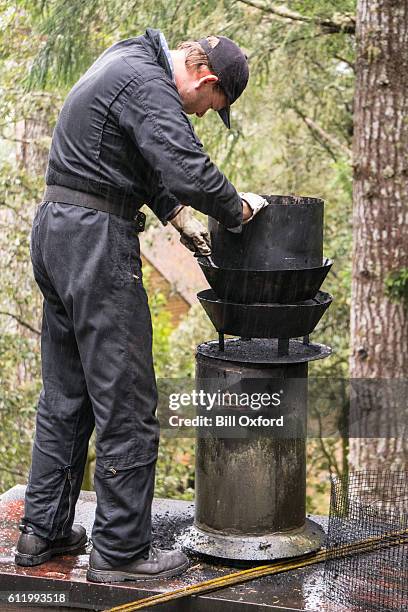 chimney sweep cleaning chimney - chimney sweeping stock pictures, royalty-free photos & images