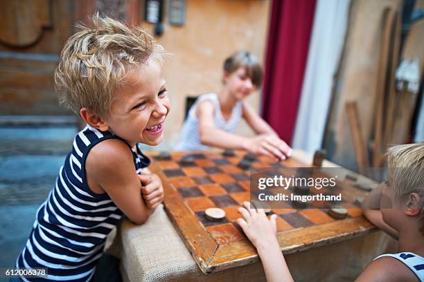 niños felices jugando a las damas en la calle - volterra fotografías e imágenes de stock