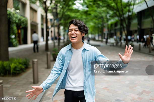 casual japanese man portrait on the street have fun - japanese ethnicity stockfoto's en -beelden