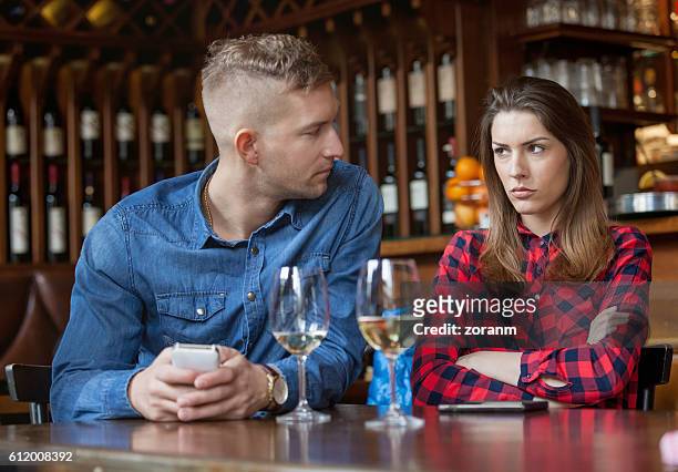 couple having disagreement in caffe - bored girlfriend stock pictures, royalty-free photos & images