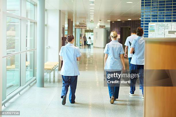 nurses in the hospital corridor - hospital hall stockfoto's en -beelden