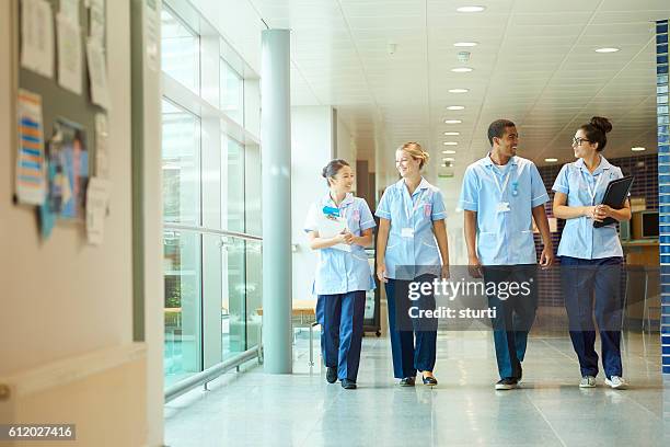 happy young nurse team . - four people stock pictures, royalty-free photos & images